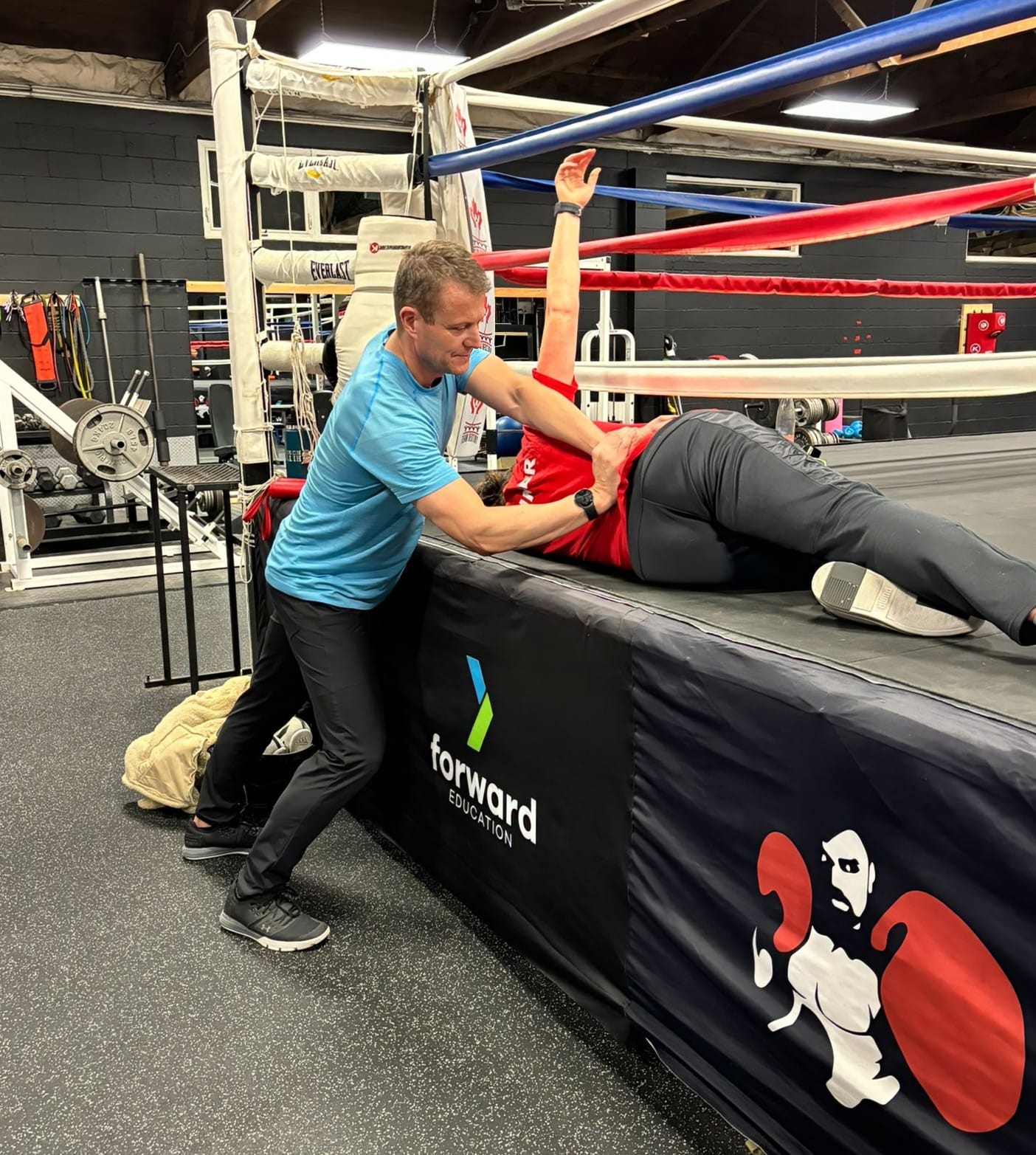 Kevin treating a boxer ringside at a boxing gym